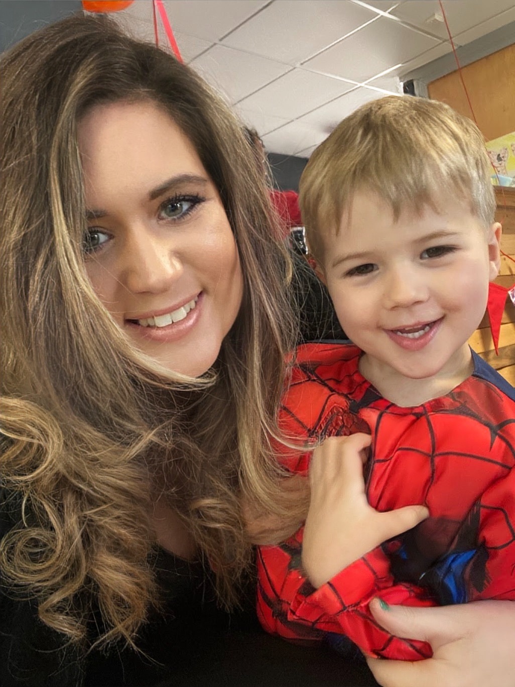 Dr Stephanie Wilson, Founder of She's In Business, smiling close with her youngest son