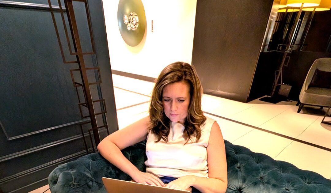Dr Stephanie Wilson working on her laptop, building a business from her expertise